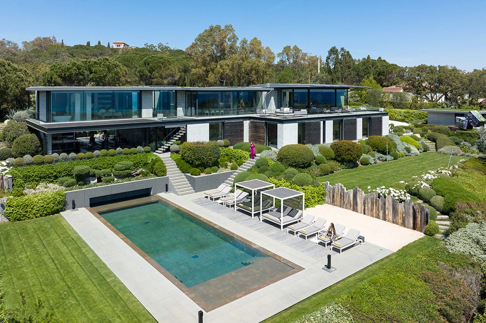 A contemporary villa above the coast, pool and terraced gardens.